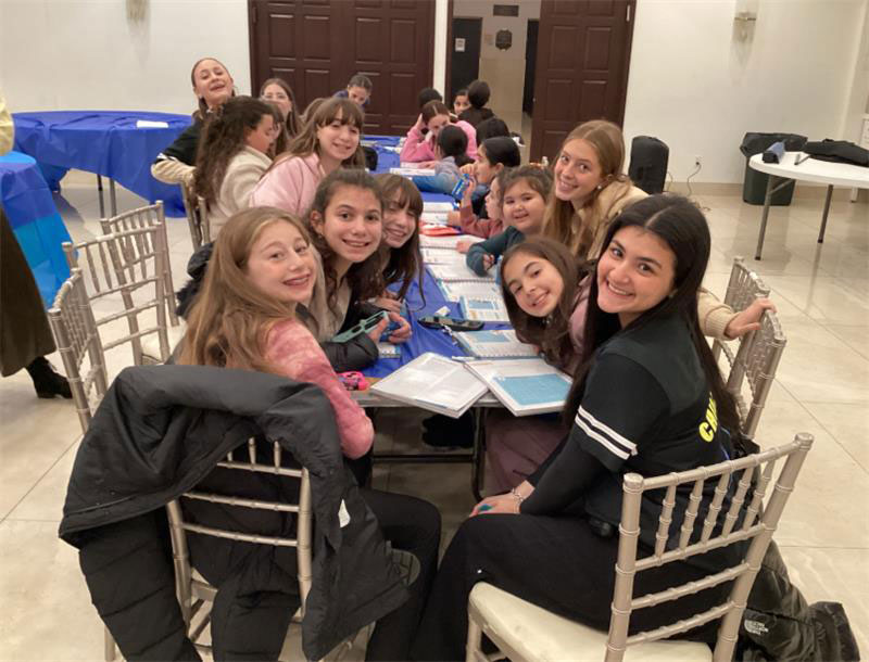Smiling Chillers around a table at a weekly ChillZone program